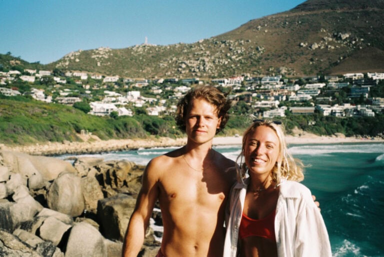 friends on the beach in Cape Town talking about the best cape town hostels