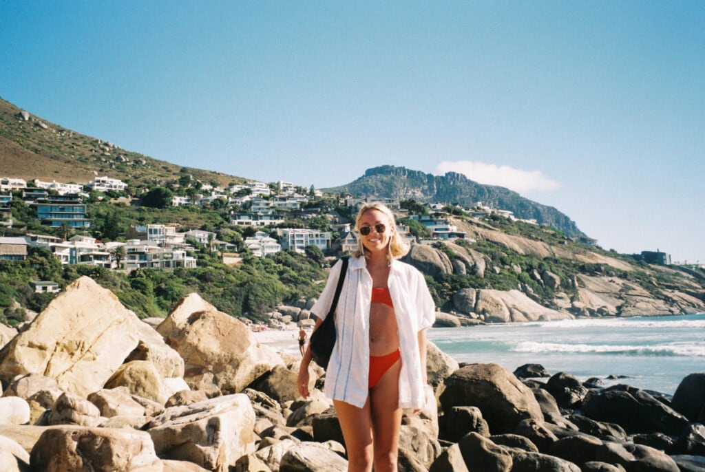 girl standing at Llandudno beach in cape town how I accidentally became a travel content creator