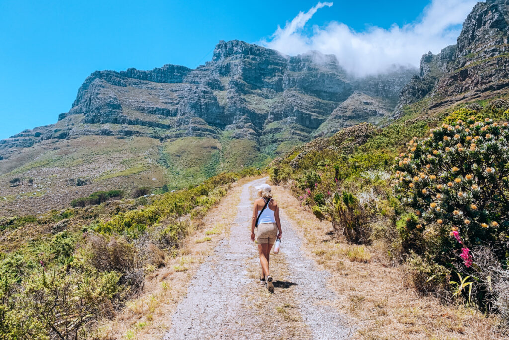 girl hiking up a mountain in Cape Town weather in december