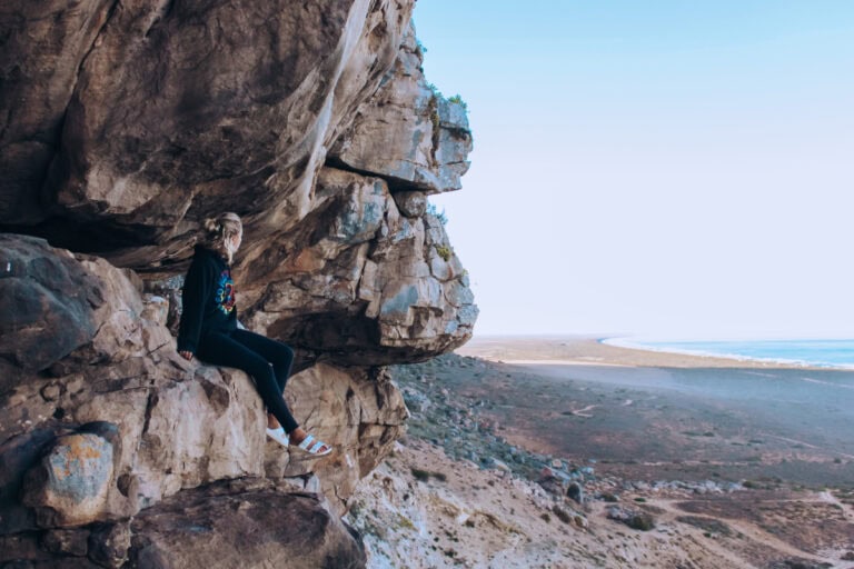 girl sitting in elands bay cave spellbound travels