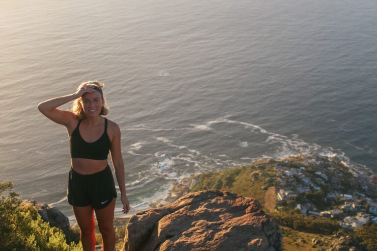 girl standing on top of Lion's Head in Cape Town: part of a cape town itinerary 7 days