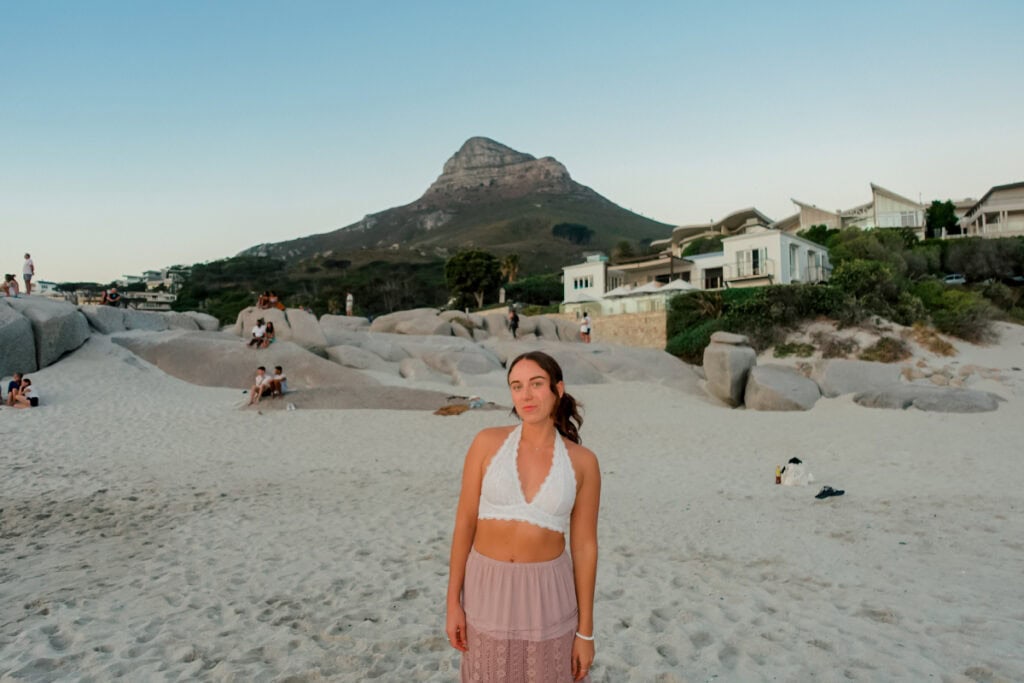 girl standing on camps bay beach in cape town